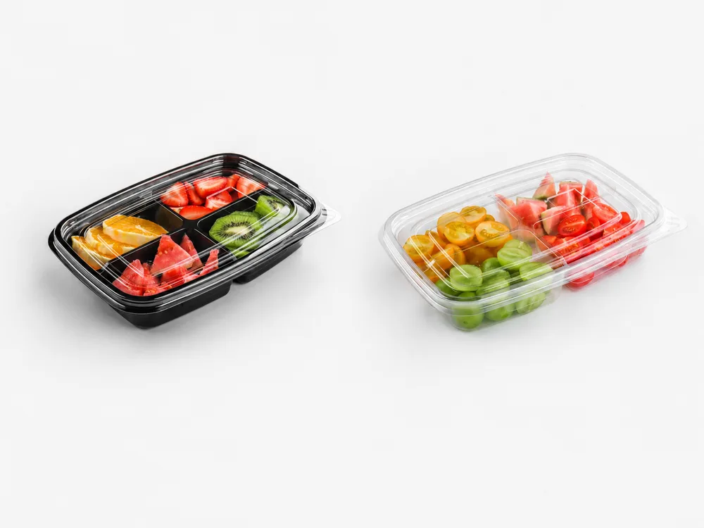 Fresh-cut fruit trays with clear lids showcasing prepared mixed fruits in plastic containers