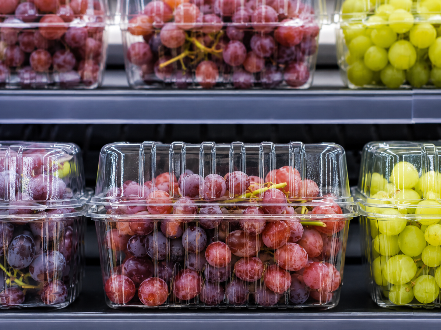 Clear PET grape clamshells displayed on a supermarket shelf for better retail presentation