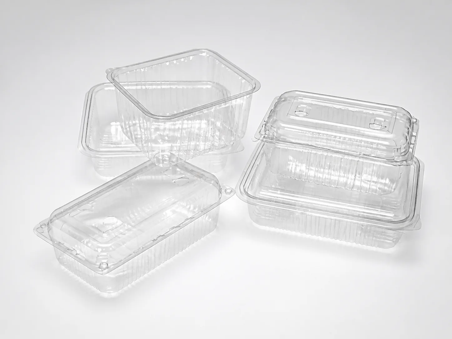 Assortment of clear PET containers for fresh and cold foods.