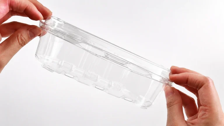 Inspecting the snap closures on a disposable plastic food container.