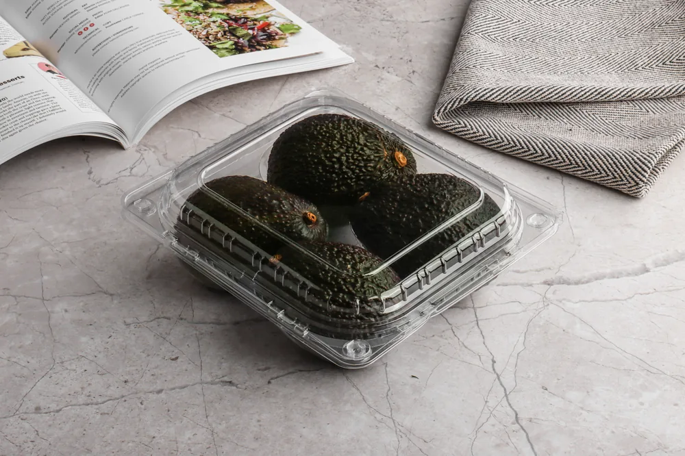 STL-014A 4-cavity avocado clamshell container holding four fresh avocados (scene)
