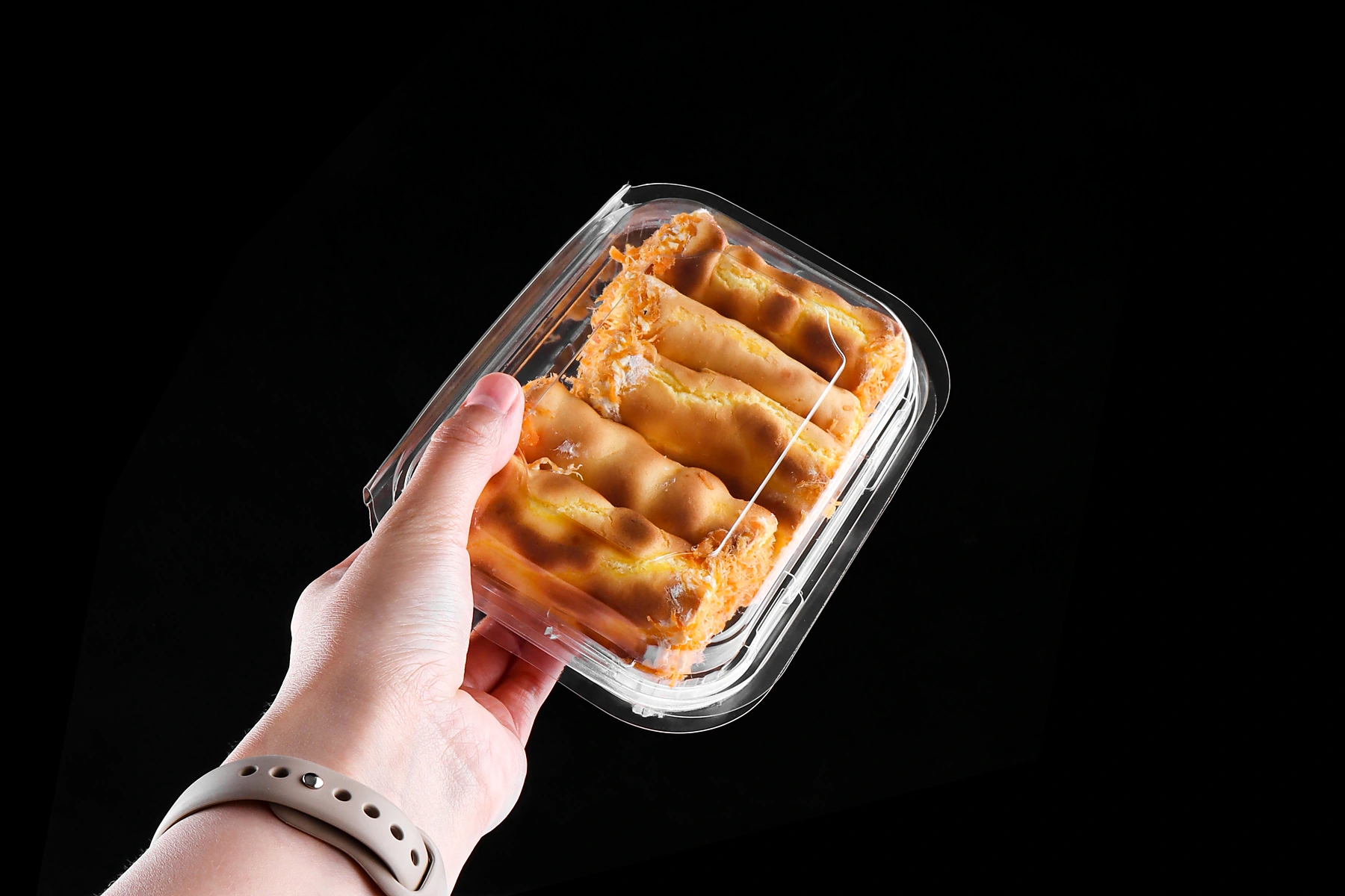 STL-200M plastic cookie container held in hand showing size