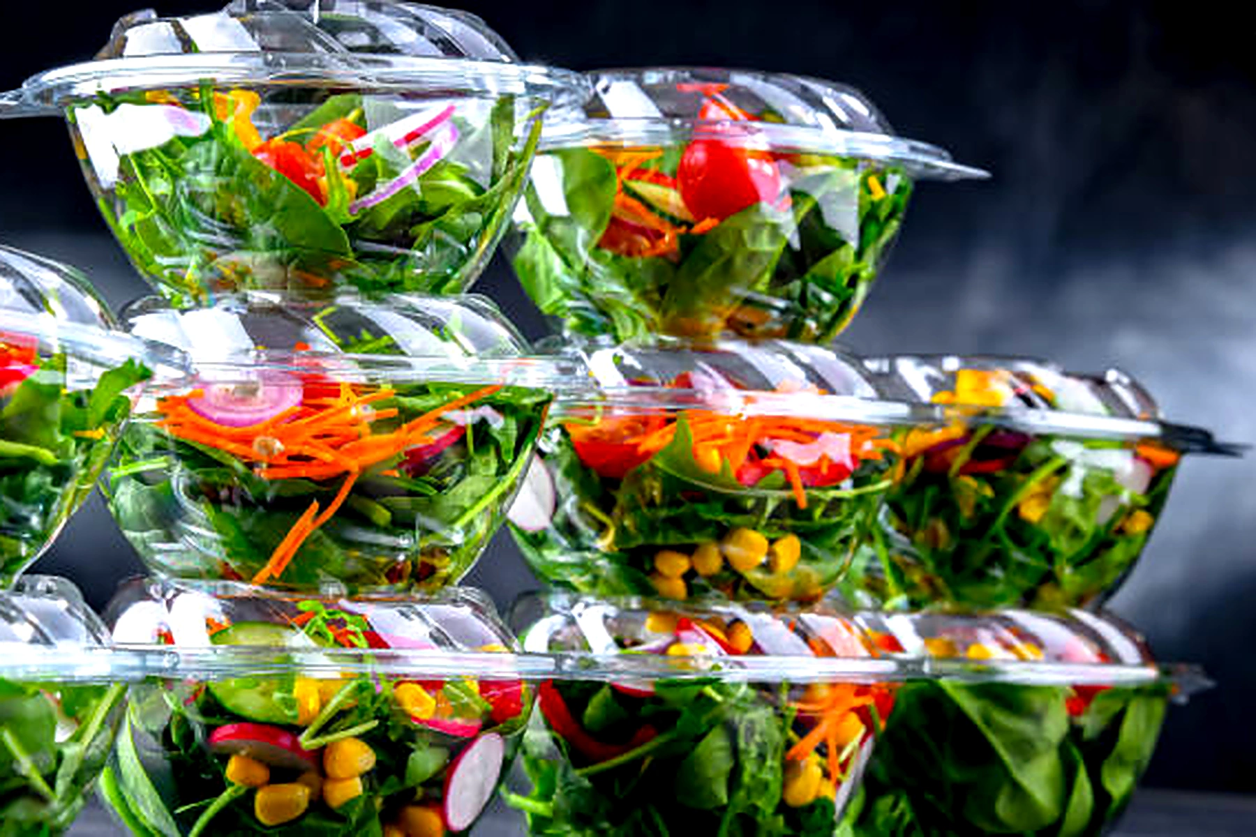 Stacked clear plastic salad containers