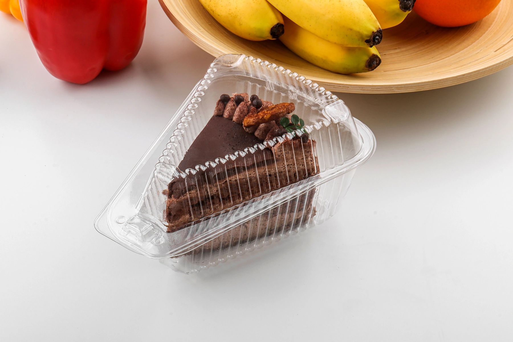 Triangular plastic cake container in lifestyle setting