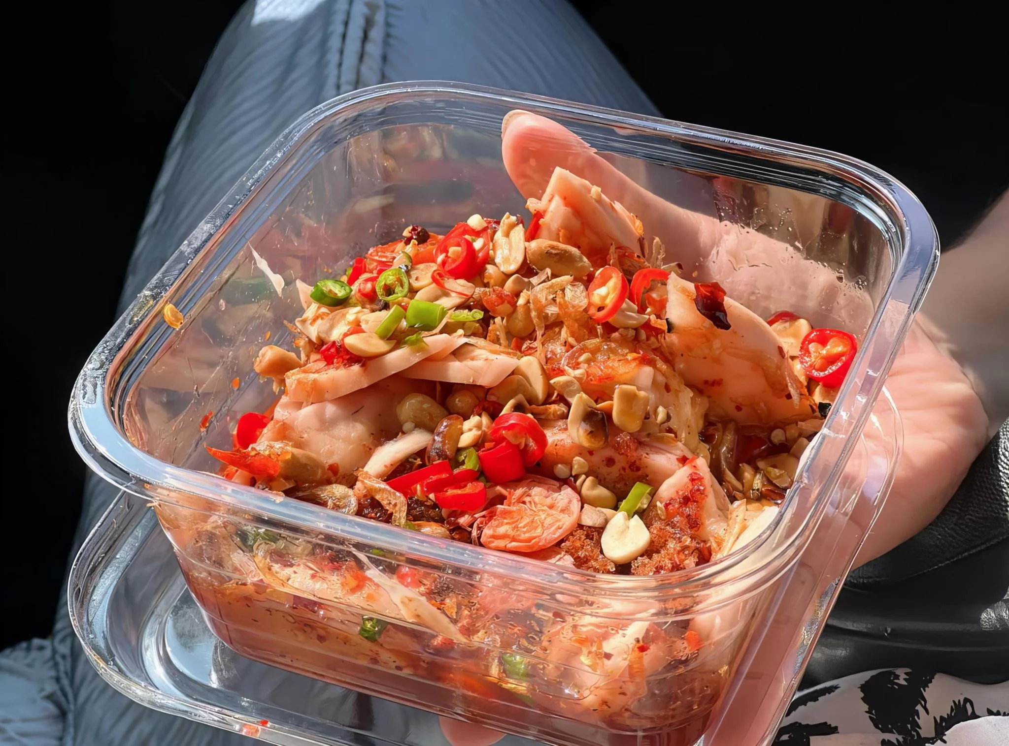 Checking the tamper-evident closure on a clear salad container.