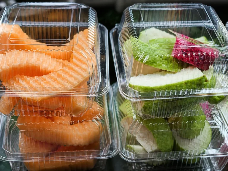 Clear clamshell packaging presenting fresh-cut fruit for retail display.