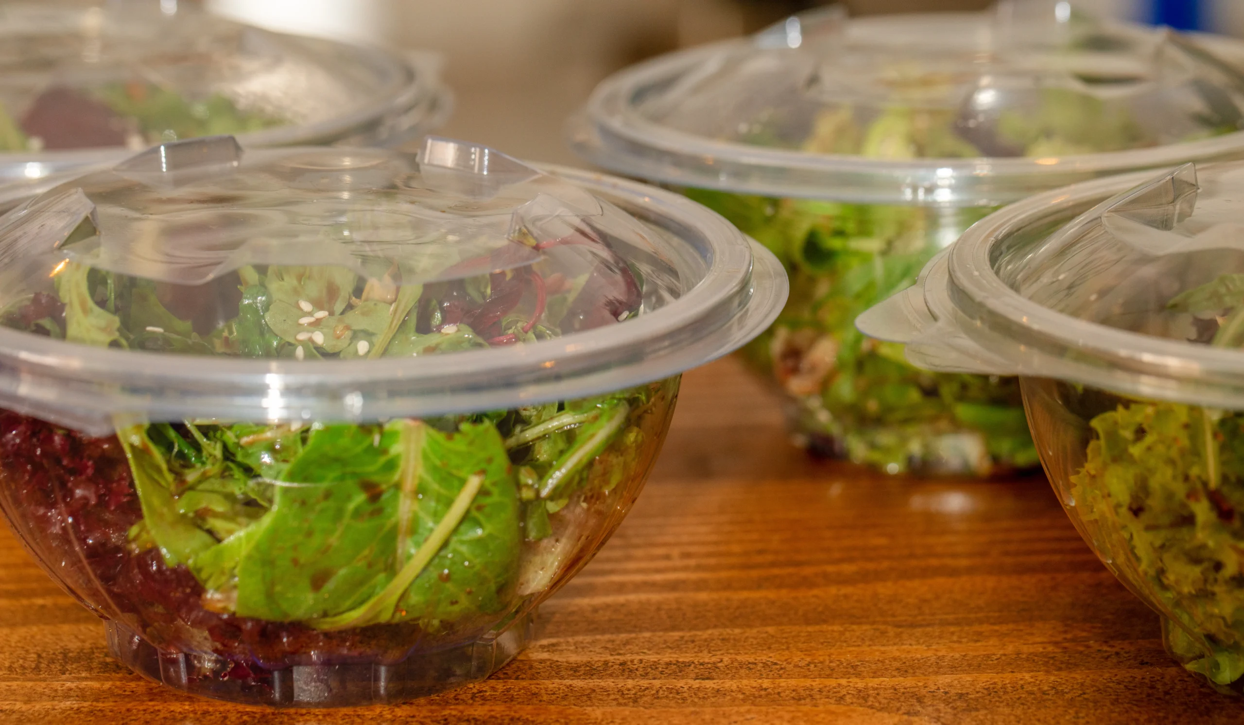 Close-up of a clear salad container showing product visibility.
