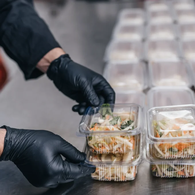 Food service employee preparing a ready-to-eat salad.