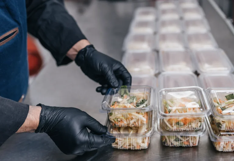 Food service employee preparing a ready-to-eat salad.