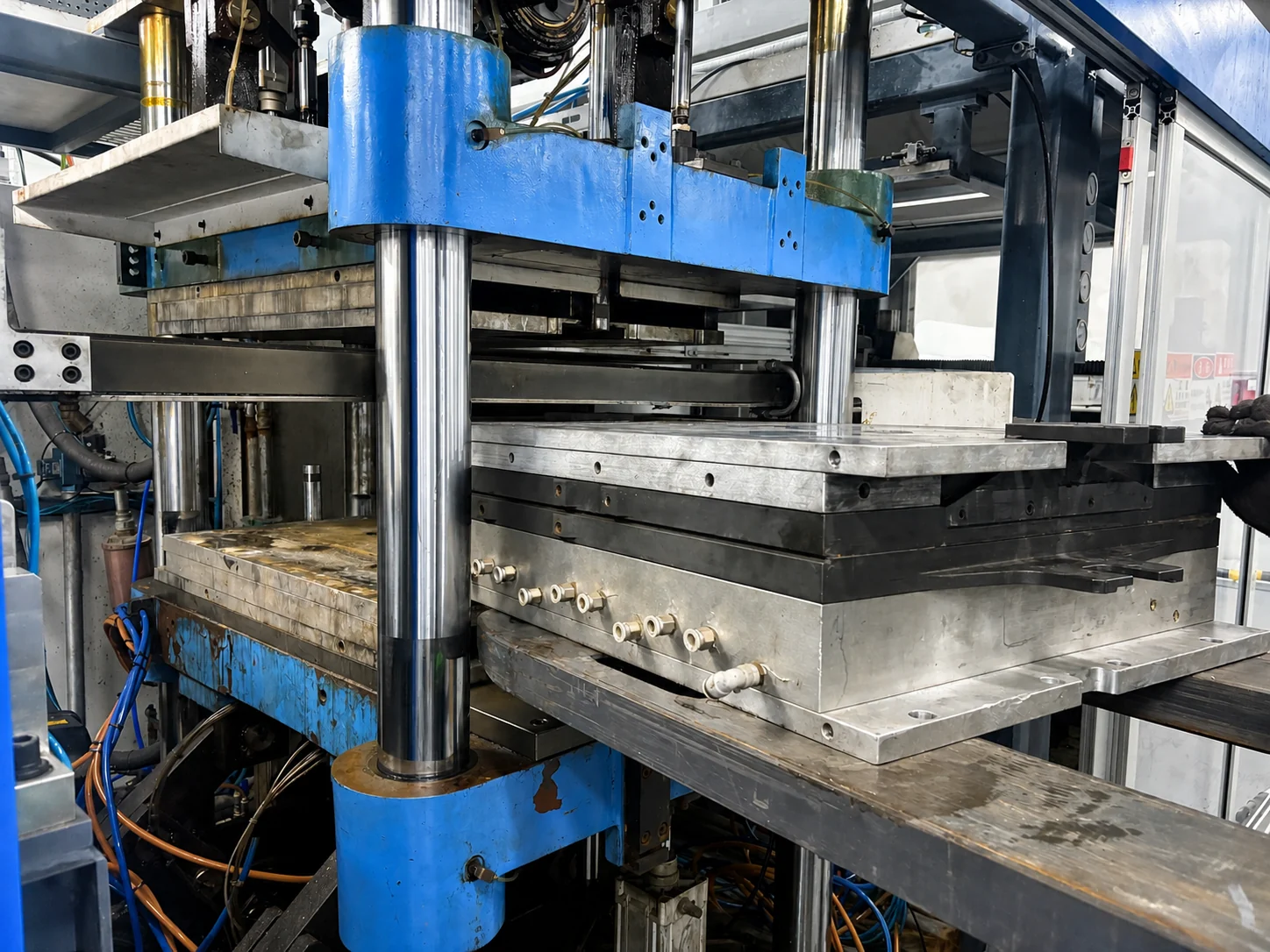 Food packaging mold loaded into a thermoforming machine for production.