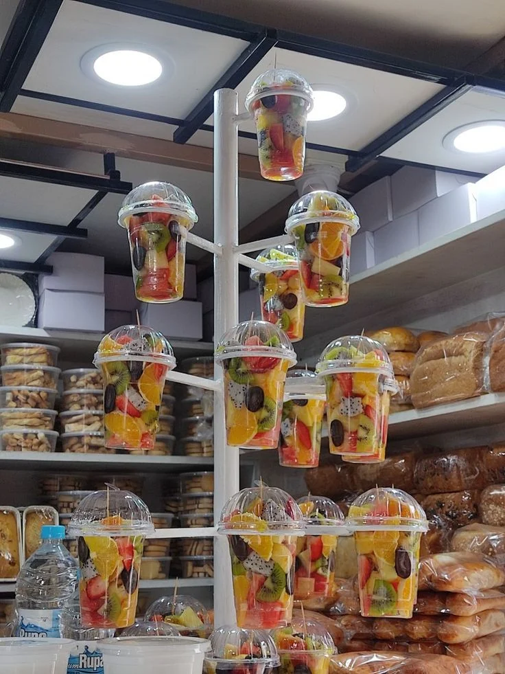 Clear cups displaying packaged fresh-cut fruit for retail.