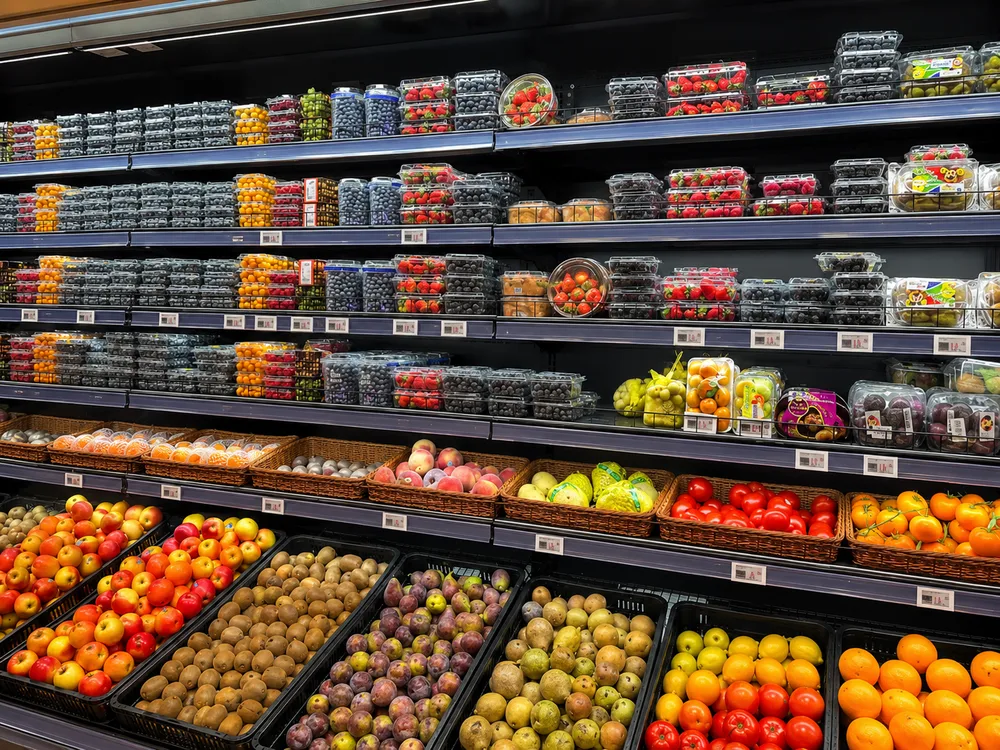PET fruit packaging containers in refrigerated supermarket retail display for fresh produce