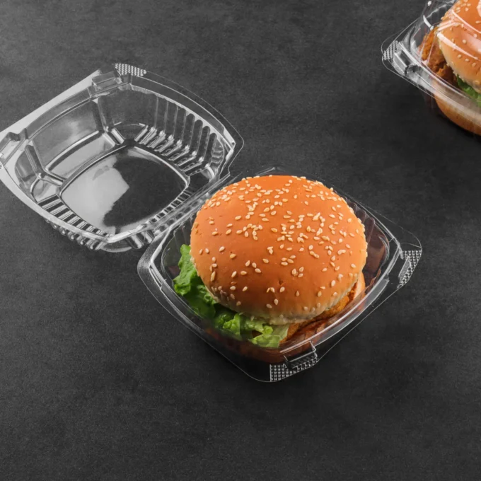 Hinged-lid plastic burger containers displayed for food service use.