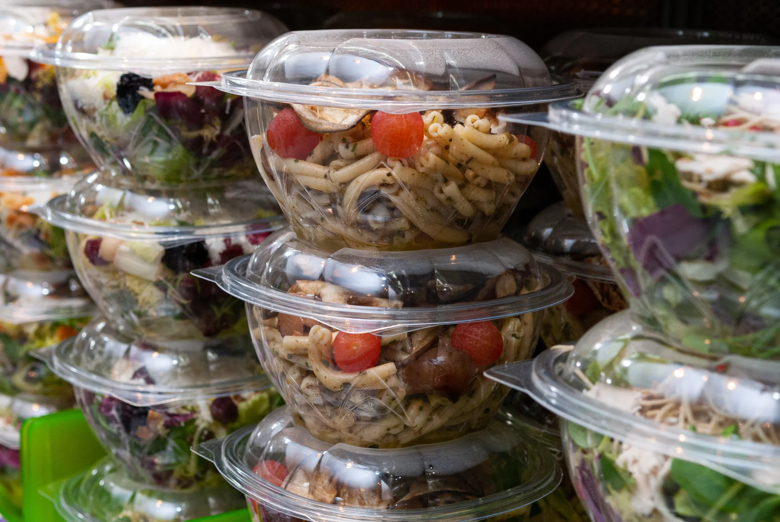 Stacked clear containers for fresh-cut fruit and salads.