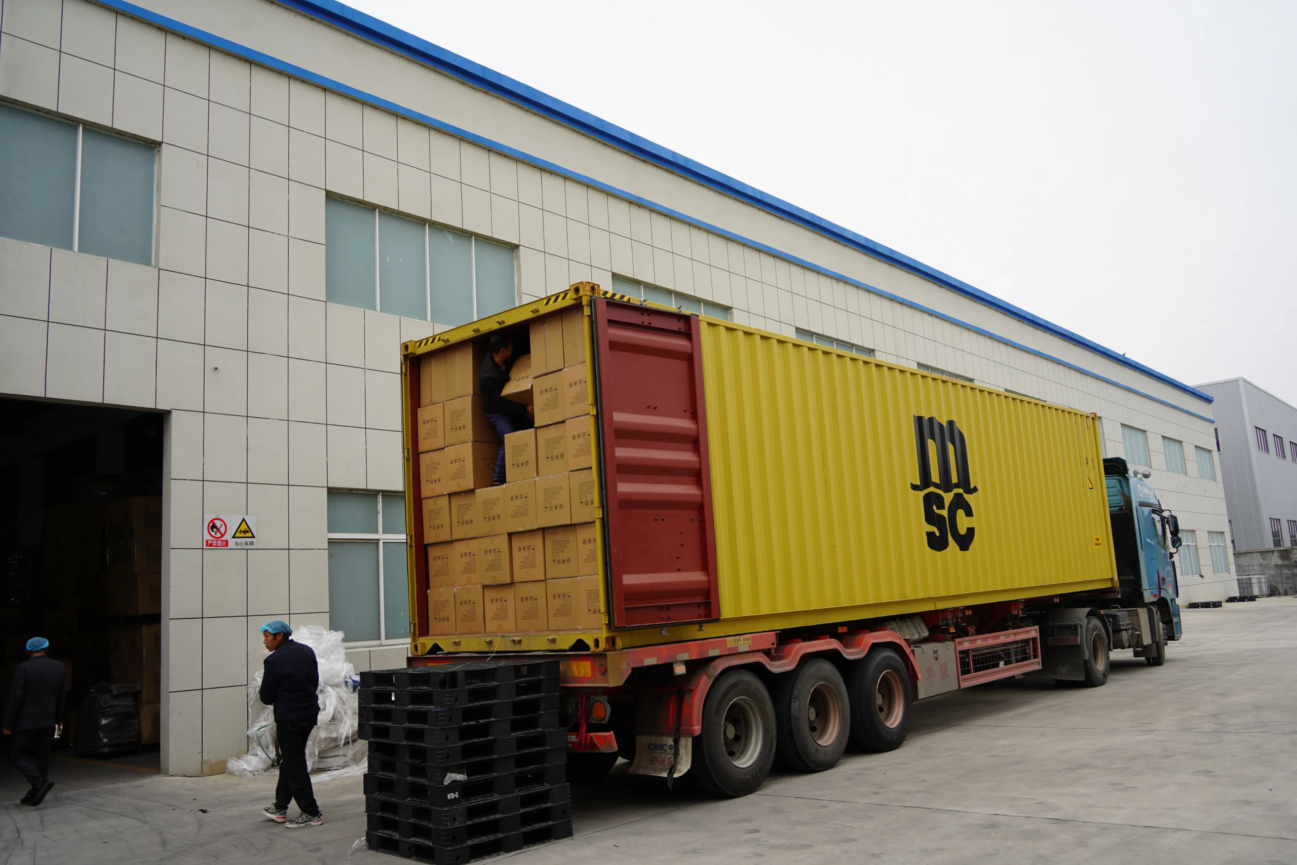Cartons of plastic food containers being loaded outside the StlPak factory.
